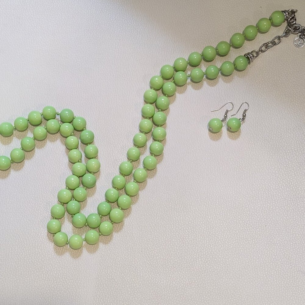 Vintage apple green knotted bead necklace. 38" with matching pierced earrings.